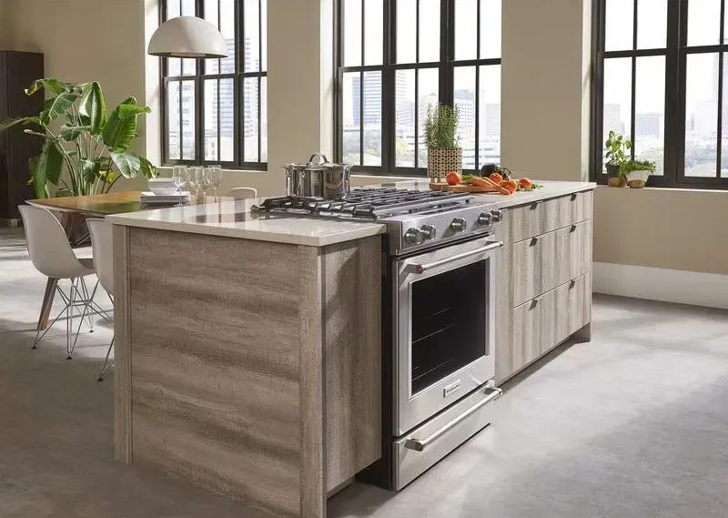 A kitchen island featuring a KitchenAid slide-in range